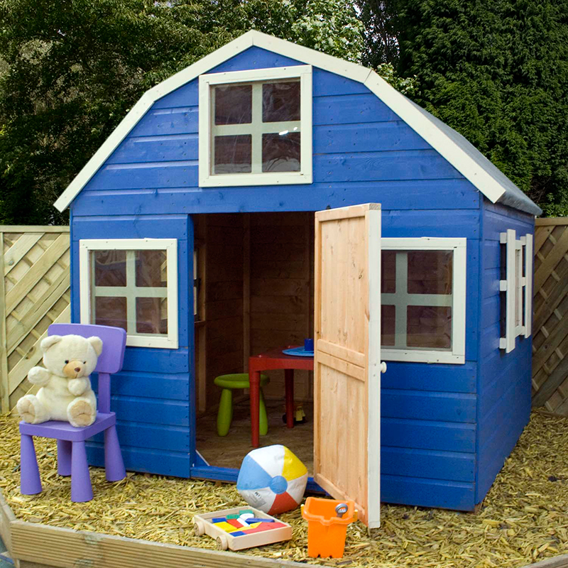 A blue dutch barn style wooden playhouse with toys 