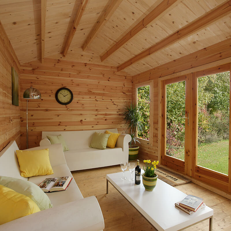 a sofa and coffee table in a log cabin