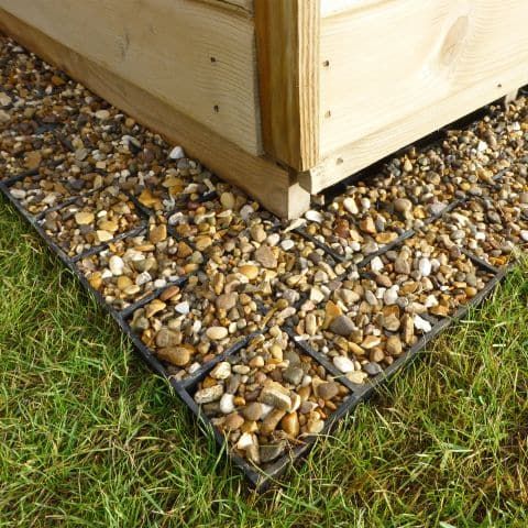 a close up of a plastic eco-base supporting a garden shed