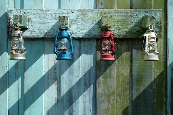 decorative lanterns on a garden fence