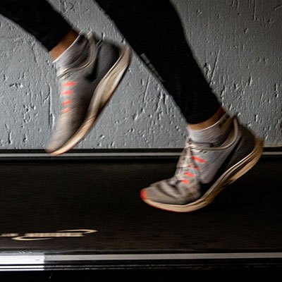a woman running on a treadmill