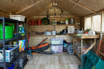 inside a shed with suspended shelving across the far wall