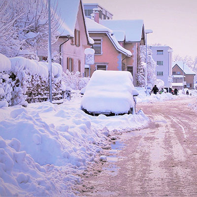 a residential street covered in snow