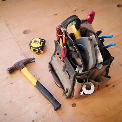 A Tool Kit containing tools such as a hammer, a measuring tape, a screwdriver and pliers