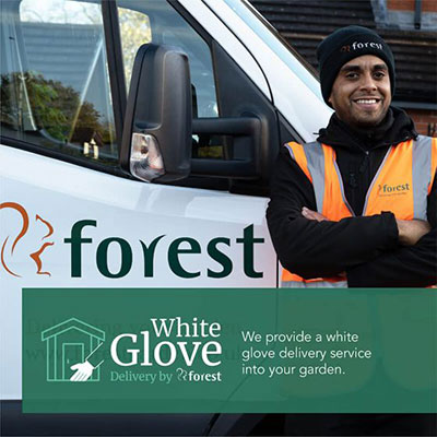 a man standing next to a white van, advertsing Forest's White Glove shed delivery service