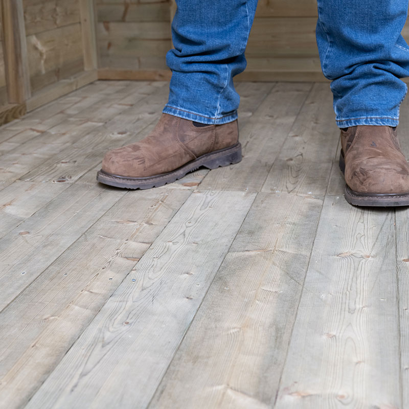 a man stood on the tongue and groove floor of a Forest Premium Shed