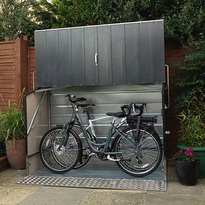 a very secure, grey metal bike shed containing 2 bicycles