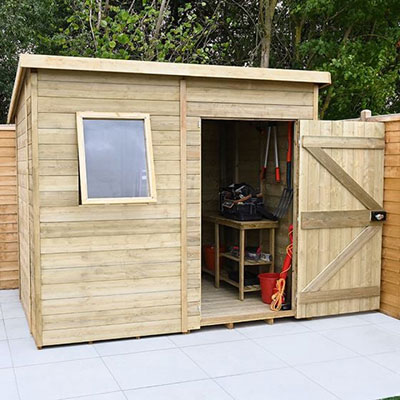 a pent wooden shed with a single open door and window