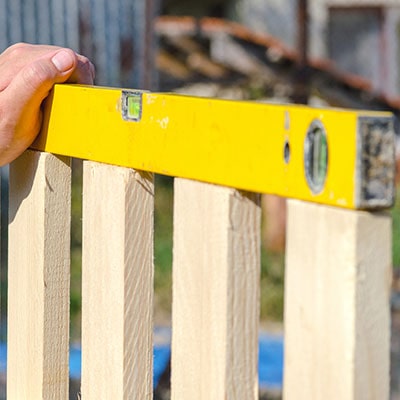 A spirit level on top of a garden fence