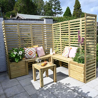 a wooden garden seating set, including benches, tables, planters and trellis