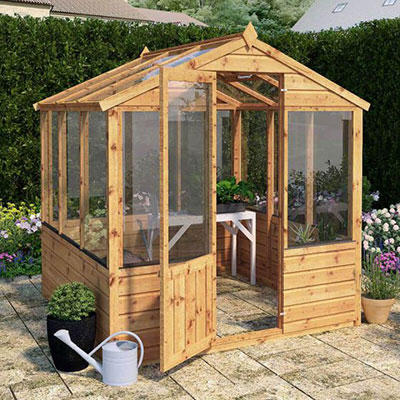 a 6x6 wooden greenhouse on a patio