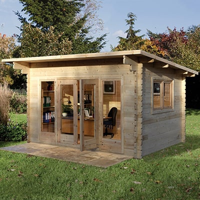 a garden log cabin with pent roof and furnished as a garden office
