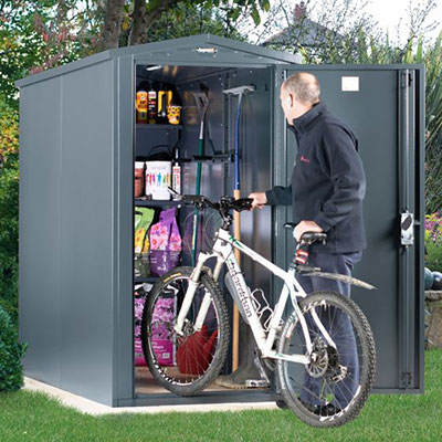 a man putting a bicycle inside a grey metal bike shed