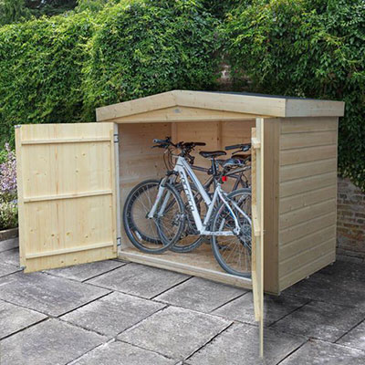 a wooden bike shed containing 2 adult bikes