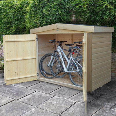 a wooden bike shed containing 2 bicycles