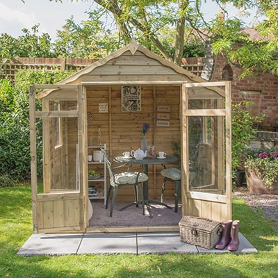 The Forest Oakley 7x5 Wooden Summerhouse with doors open to show bistro set
