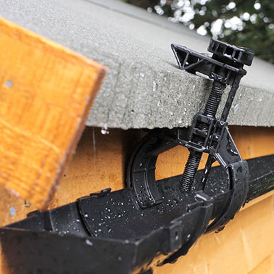 black plastic guttering attached to a shed's roof