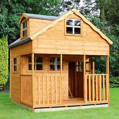 a 2 storey wooden playhouse with a veranda and 6 windows