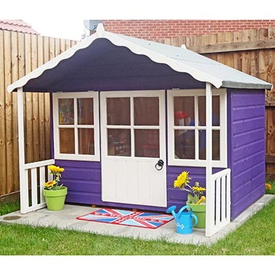a wooden Wendy house, painted purple and white, with a veranda
