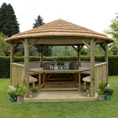 A large garden gazebo, made of wood and with a thatched roof