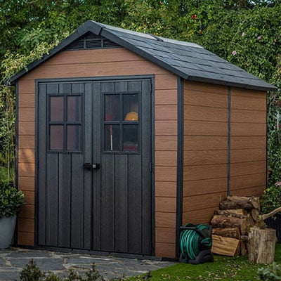 A 2-tone brown plastic shed with partially-glazed double doors and an apex roof