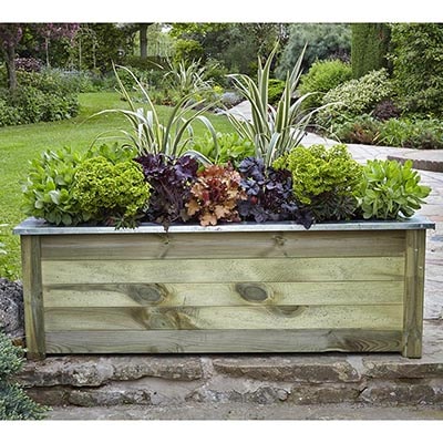 a 5x2 wooden planter full of green, brown and dark purple plants