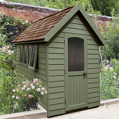 a luxurious green wooden shed with 3 windows and a partially-glazed door