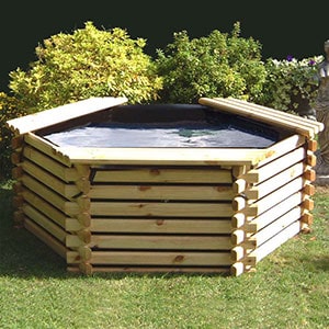 A raised, wooden fish pond with sump, positioned on a lawn.