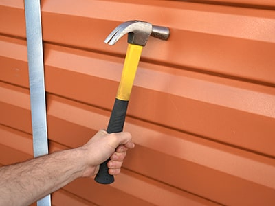 plastic shed panel being hit by a hammer as strength test