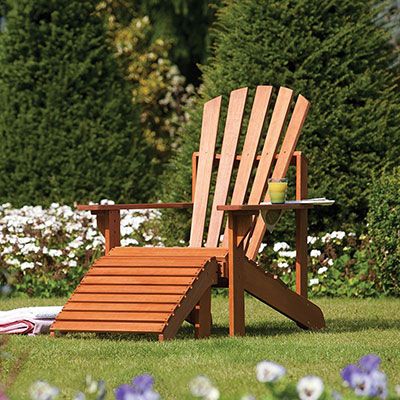 a wooden Adirondack chair, situated on a lawn