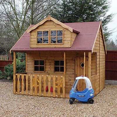 a wooden playhouse with a veranda, dormer area and red roof covering