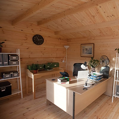 The interior of the Forest Garden Chiltern Log Cabin being used as a garden office