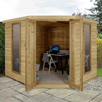 A corner summerhouse used as a garden office for working from home