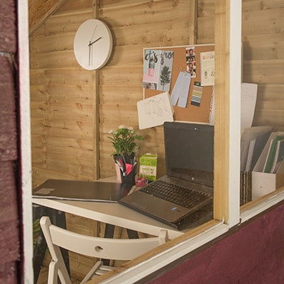 the view into a garden shed window to see a home office