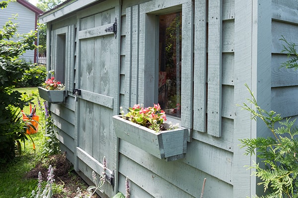 a shed with window boxes
