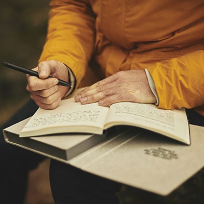 a man writing in a diary